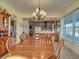 Open dining room with long wood table and seating for many at 48665 Bermont Rd, Punta Gorda, FL 33982