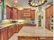 Island kitchen with granite countertops and wood cabinets at 48665 Bermont Rd, Punta Gorda, FL 33982