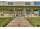Inviting front porch with stone detailing and a brick walkway at 48665 Bermont Rd, Punta Gorda, FL 33982