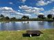 Tranquil pond reflecting the blue sky and fluffy clouds at 48665 Bermont Rd, Punta Gorda, FL 33982