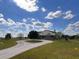 Two-story home with a circular driveway and large yard at 48665 Bermont Rd, Punta Gorda, FL 33982