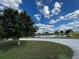 Long driveway leading to a home with a pond view at 48665 Bermont Rd, Punta Gorda, FL 33982