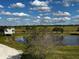 Picturesque pond with lush greenery and a small structure at 48665 Bermont Rd, Punta Gorda, FL 33982