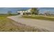 Gravel driveway leading to a large two-story home at 48665 Bermont Rd, Punta Gorda, FL 33982