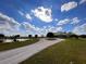 Two-story home with a pond view and a circular driveway at 48665 Bermont Rd, Punta Gorda, FL 33982