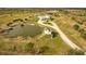 Aerial view showing the house, pond, and surrounding land at 48665 Bermont Rd, Punta Gorda, FL 33982