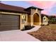 Two-car garage and walkway leading to the front entrance of the house at 4209 Titan St, North Port, FL 34286