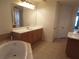 Bathroom with double sinks, vanity, and corner tub at 97 Vivante Blvd # 9749, Punta Gorda, FL 33950