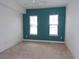 Bedroom with teal accent wall and two windows at 97 Vivante Blvd # 9749, Punta Gorda, FL 33950