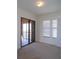 Bedroom with sliding doors to balcony at 97 Vivante Blvd # 9749, Punta Gorda, FL 33950