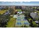 Aerial view of the community including shuffleboard courts, pool, and pickleball courts at 3006 Caring Way # 325, Port Charlotte, FL 33952