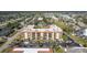 Large condo complex with many parking spaces, tennis courts, and community pool with lush landscaping at 3006 Caring Way # 325, Port Charlotte, FL 33952