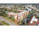 An aerial view of a large condominium complex in a developed area, showcasing a pool and ample parking at 3006 Caring Way # 325, Port Charlotte, FL 33952
