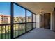Enclosed balcony boasts views of the building and landscape and a ceiling fan at 3006 Caring Way # 325, Port Charlotte, FL 33952
