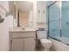 Bathroom featuring vintage blue shower tiles, a mirrored cabinet, and tile flooring at 3006 Caring Way # 325, Port Charlotte, FL 33952