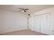 Bedroom features neutral carpeting, a ceiling fan and double door closet at 3006 Caring Way # 325, Port Charlotte, FL 33952