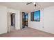 Bright bedroom features neutral carpeting, access to the enclosed balcony and a closet at 3006 Caring Way # 325, Port Charlotte, FL 33952