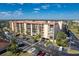 A tan condo building has plenty of parking spaces and is located near beaches, dining, and shopping at 3006 Caring Way # 325, Port Charlotte, FL 33952