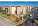 Three story condominium complex highlighting well maintained landscaping, parking, and many windows at 3006 Caring Way # 325, Port Charlotte, FL 33952
