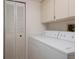 Laundry room featuring white washer and dryer, closet and cabinets for ample storage at 3006 Caring Way # 325, Port Charlotte, FL 33952