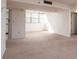 Bright living room features neutral carpeting, and lots of natural light from a large window at 3006 Caring Way # 325, Port Charlotte, FL 33952