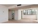 Bright living room features neutral carpeting, and lots of natural light from a large window at 3006 Caring Way # 325, Port Charlotte, FL 33952