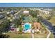 Community pool and tennis courts offer residents recreational opportunities, set amidst tropical landscaping at 3006 Caring Way # 325, Port Charlotte, FL 33952