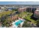 Aerial shot of the community pool surrounded by palm trees and lush landscaping, a great place to relax at 3006 Caring Way # 325, Port Charlotte, FL 33952