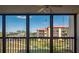 A beautiful view of a green lawn with a multi-story building in the background, seen through windows at 3006 Caring Way # 325, Port Charlotte, FL 33952