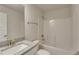 Bathroom featuring granite countertop, white cabinets and a tub with shower at 3482 Dunkirk St, Port Charlotte, FL 33980