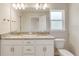 Bright bathroom featuring a double vanity with granite countertop, white cabinets and a window at 3482 Dunkirk St, Port Charlotte, FL 33980