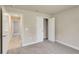 Bedroom with neutral carpet and trim, a closet and entry to the hall at 3482 Dunkirk St, Port Charlotte, FL 33980