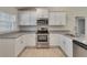Well-equipped kitchen featuring stainless steel appliances, granite countertops, and white cabinets at 3482 Dunkirk St, Port Charlotte, FL 33980