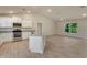 Modern kitchen with stainless steel appliances, granite countertops, a center island, and wood-look tile floors at 3482 Dunkirk St, Port Charlotte, FL 33980