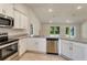 Modern kitchen features stainless steel appliances, granite countertops, and ample cabinet space at 3482 Dunkirk St, Port Charlotte, FL 33980