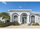 Front entrance of a home with double arched entryways and gray door at 7417 S Moss Rose, Punta Gorda, FL 33955