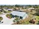 Aerial view of the back of a light green house with a metal roof and a yard at 470 Ridgecrest Dr, Punta Gorda, FL 33982