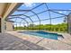 Inviting pool and patio area with screened enclosure, perfect for outdoor relaxation at 9437 Galaxie Cir, Port Charlotte, FL 33981