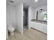 A bathroom with dual sinks, granite countertops, and a walk-in shower with neutral tiling at 8285 Agate St, Port Charlotte, FL 33981
