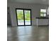 A living room featuring light hardwood floors, and glass doors leading to the pool at 8285 Agate St, Port Charlotte, FL 33981