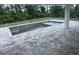 The home features an outdoor patio with decorative pavers surrounding a concrete pool at 8285 Agate St, Port Charlotte, FL 33981