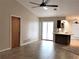 Living room with tile floors, kitchen access, and sliding door at 5412 Ulysses St, Port Charlotte, FL 33981
