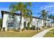 Two-story condo building with palm trees and walkway at 25100 Sandhill Blvd # Y201, Punta Gorda, FL 33983
