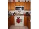Kitchen with wood cabinets, granite countertop and appliances at 25100 Sandhill Blvd # Y201, Punta Gorda, FL 33983