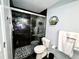 Clean bathroom with a walk-in shower and dark tile at 3106 Harbor Blvd # 3A, Port Charlotte, FL 33952