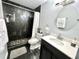 Updated bathroom with dark tile, a large vanity, and a walk-in shower at 3106 Harbor Blvd # 3A, Port Charlotte, FL 33952