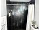 Clean bathroom with a walk-in shower and dark tile at 3106 Harbor Blvd # 3A, Port Charlotte, FL 33952