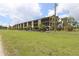 Two-story building with covered parking and a large grassy area at 14459 River Beach Dr # 202, Port Charlotte, FL 33953