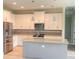 Modern kitchen with island and stainless steel appliances at 2563 Longworthy Rd, North Port, FL 34288