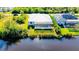 Aerial view of canal front home with pool and solar panels at 13654 Allamanda Cir, Port Charlotte, FL 33981